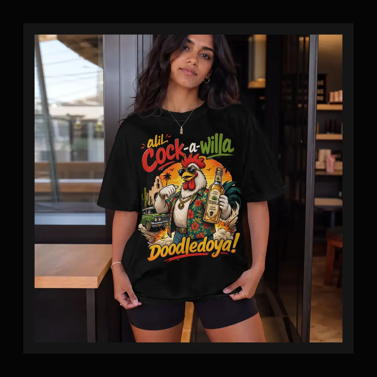 Cock-a-Willa Doodledoya Tee – tequila rooster graphic tee, framed lifestyle shot of model in a bar