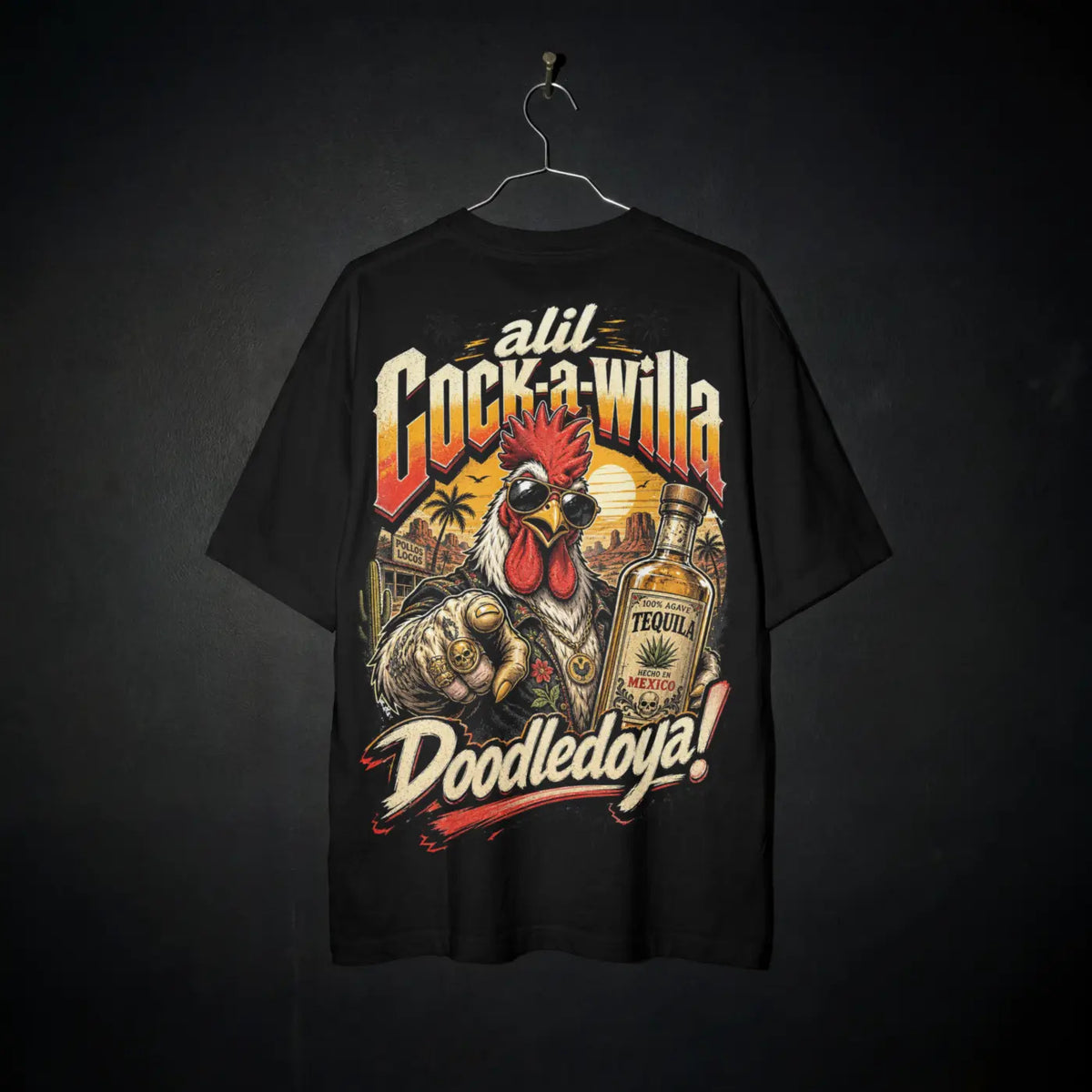 Cock-a-Willa Doodledoya Tee – tequila rooster graphic tee, tee on a hanger against black