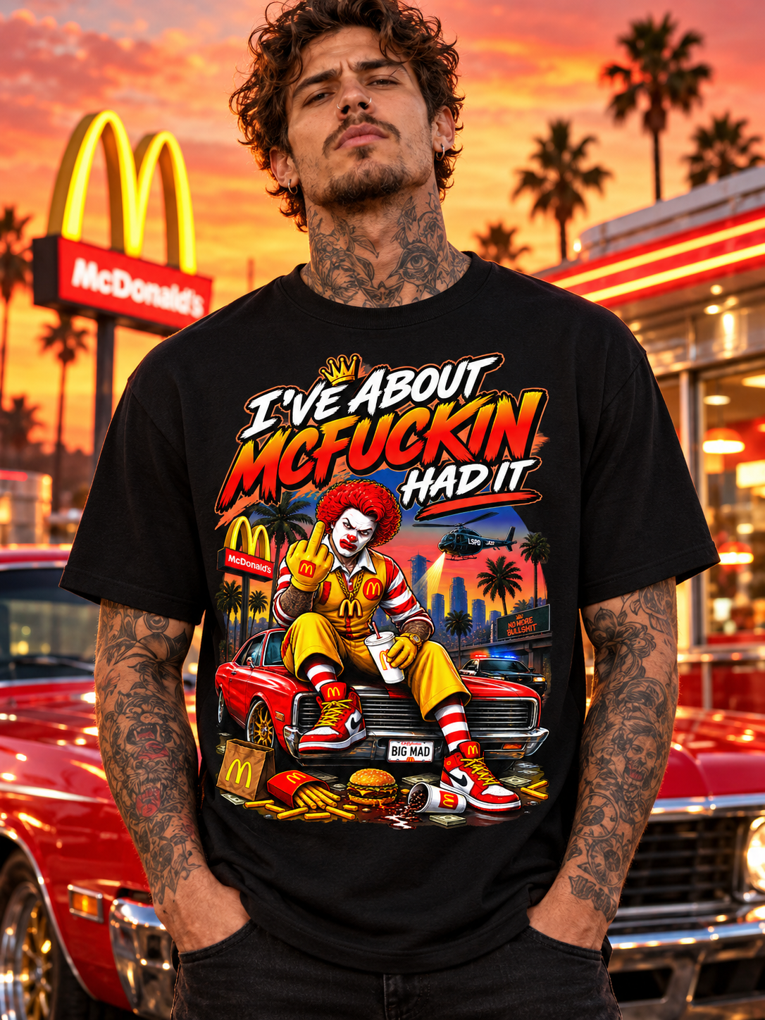 Black McFuckin Had It tee on a front-facing male model in retro roadside burger diner parking lot at sunset with red car reflections and distant palm trees.