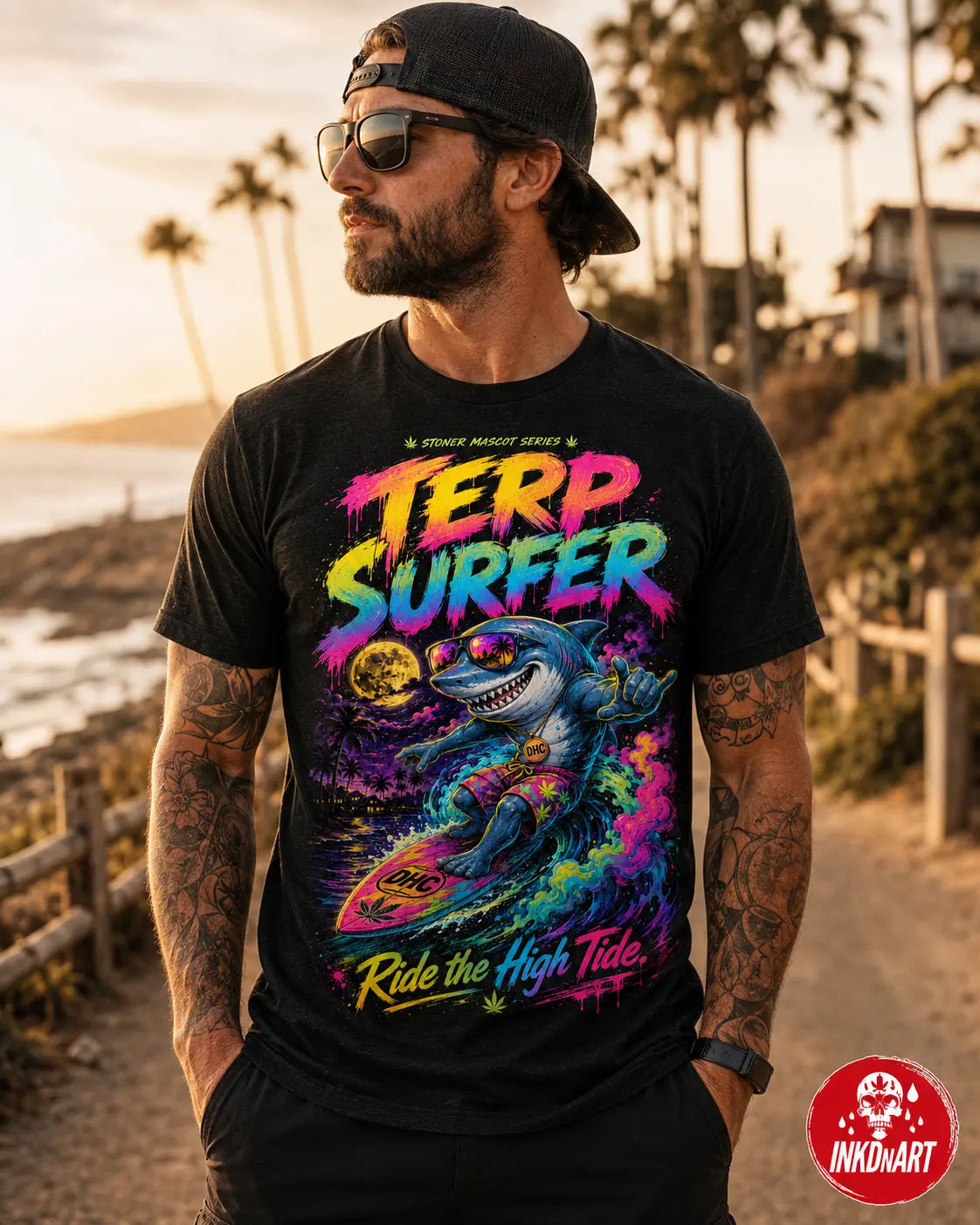Terp Surfer Tee – psychedelic skull surfer graphic tee, worn by model on a coastal boardwalk at sunset